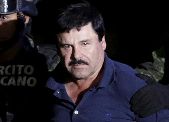 Recaptured drug lord Joaquin "El Chapo" Guzman is escorted by soldiers at the hangar belonging to the office of the Attorney General in Mexico City