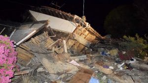 A house collapses following the earthquake in Mashiki, near Kumamoto city, southern Japan, early Friday, April 15, 2016. Rescuers in southern Japan are searching for trapped residents in at least two dozen collapsed houses, after a powerful earthquake struck. (Yuta Iida/Kyodo News via AP) JAPAN OUT, MANDATORY CREDIT